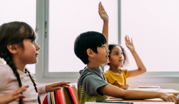 hands raised in classroom 767x418